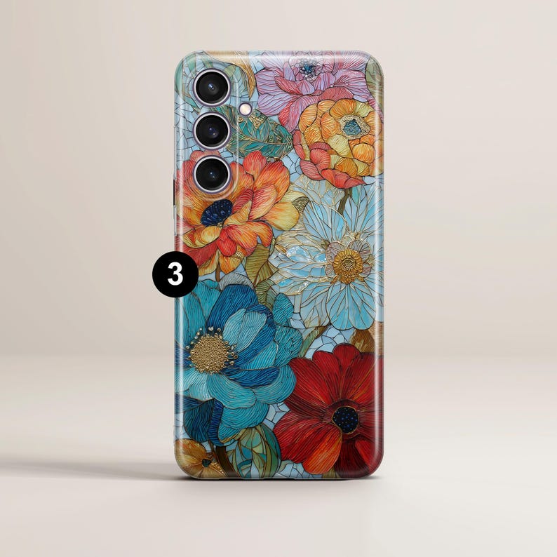 May include: A floral phone case featuring a vibrant design of colorful flowers in shades of red, orange, blue, and yellow. The case has a glossy finish and a number 3 is visible on the side.