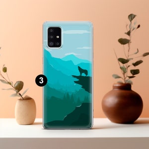 May include: A clear phone case with a wolf silhouette howling at the moon over a mountain range. The mountains are a gradient of blue and green.