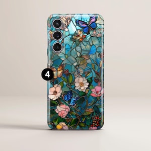 May include: A smartphone case featuring a stained-glass design with butterflies and flowers in shades of blue, pink, and yellow. The case has a glossy finish and a camera module with four lenses.