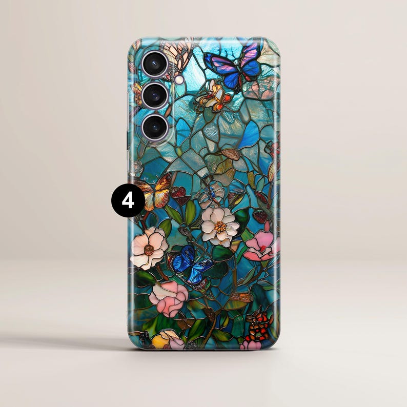 May include: A smartphone case featuring a stained-glass design with butterflies and flowers in shades of blue, pink, and yellow. The case has a glossy finish and a camera module with four lenses.