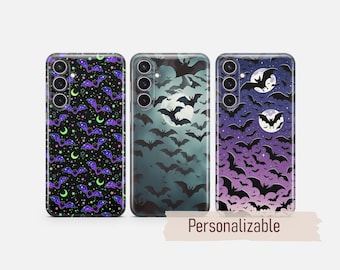 May include: Three phone cases featuring bat patterns. The first has purple bats, green moons, and stars on black. The second shows black bats against a misty moonlit sky. The third displays black bats on a purple gradient background with moons.