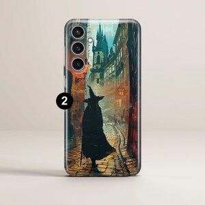 May include: A phone case with a colorful illustration of a witch walking down a cobblestone street in a medieval city. The witch is wearing a black cloak and a pointed hat. The city is filled with tall buildings and a church with a spire.