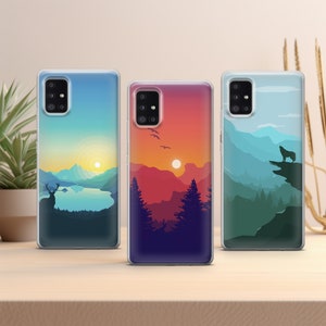 May include: Three phone cases with different nature scenes. The first case features a sunset over mountains with a deer in the foreground. The second case features a sunset over mountains with a lake in the foreground. The third case features a mountain scene with a wolf in the foreground.