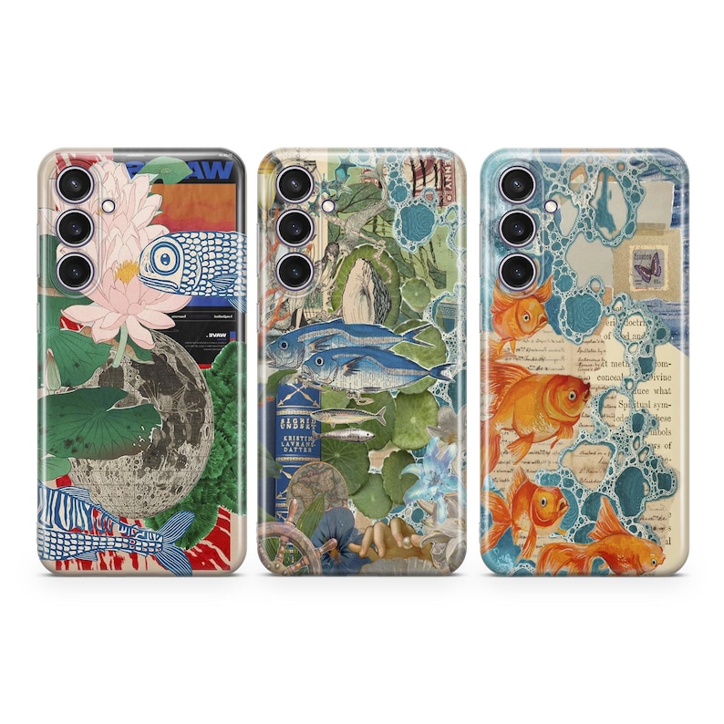 May include: Three phone cases with different designs. The first case features a blue and white fish, a pink flower, and green leaves. The second case features a blue and white fish, a book, and a hand. The third case features orange fish, blue bubbles, and a vintage postcard.