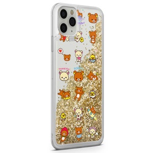 May include: A clear phone case with a gold glitter background and a pattern of brown bears with different expressions and poses. The bears are wearing different outfits and accessories, including a heart, a flower, a hat, and a surfboard. The text "Thank You!" and "Sorry" are also visible on the case.