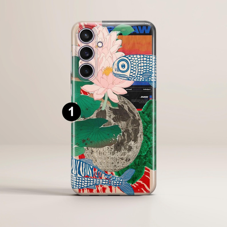 May include: A phone case with a colorful design featuring a lotus flower, fish, and a moon. The case has a cutout for the camera lens and a white background.