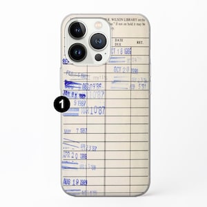 May include: A close-up of a library card with a clear plastic case. The card has a date due section with the date "Oct 18 1989" written in blue ink. The card also has a return date section with the date "Oct 20 1990" written in blue ink.