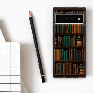 May include: A smartphone case featuring a detailed illustration of a bookshelf filled with books in shades of brown and green. A black pencil and a white notebook with a grid pattern are also visible.