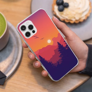 May include: A clear phone case with a sunset landscape design. The case features a silhouette of mountains, trees, and a setting sun. The case is designed for an iPhone with a triple camera lens.