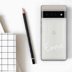 Op de afbeelding: Een witte telefoonhoes met een zwarte camera lens en de naam "Emma" in wit schrift op de achterkant.