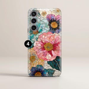 May include: A floral phone case featuring a colorful design of stylized flowers in shades of pink, blue, yellow, and purple. The case has a glossy finish and a camera cutout on the upper left.