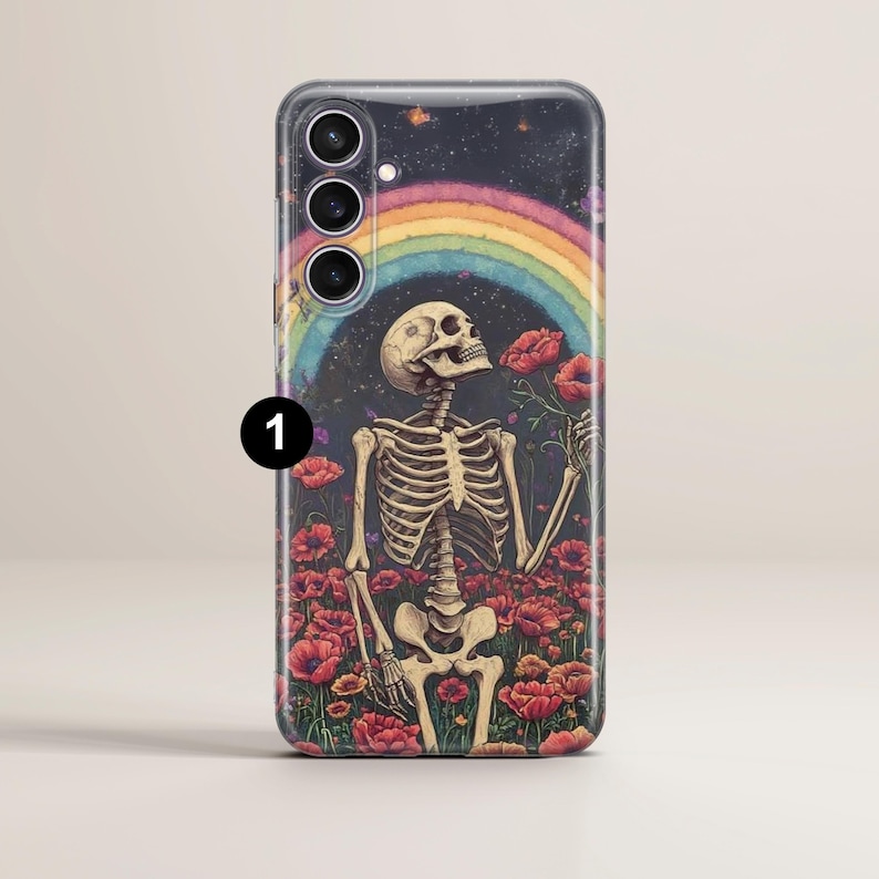 May include: A phone case featuring a colourful rainbow and a skeleton holding a flower. The background is a dark blue with stars. The skeleton is wearing a flower crown.
