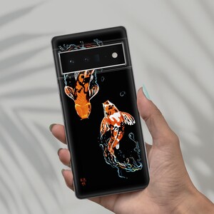May include: Black phone case with a design of two orange and white koi fish swimming in a black background. The case has a camera lens cutout and the text "森林" in Japanese.