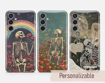 May include: Three phone cases with different designs featuring skeletons and flowers. The first case has a rainbow and a skeleton holding a flower. The second case has a skeleton holding a flower in a field of flowers. The third case has two skeletons embracing with a moon and text that says "I want you. All of you".