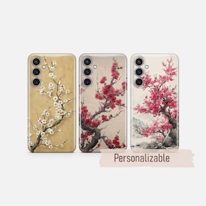 May include: Three phone cases with floral designs. The first case has a beige background with white flowers. The second case has a beige background with red flowers. The third case has a white background with pink flowers and a mountain scene. The word "Personalizable" is written on a banner.