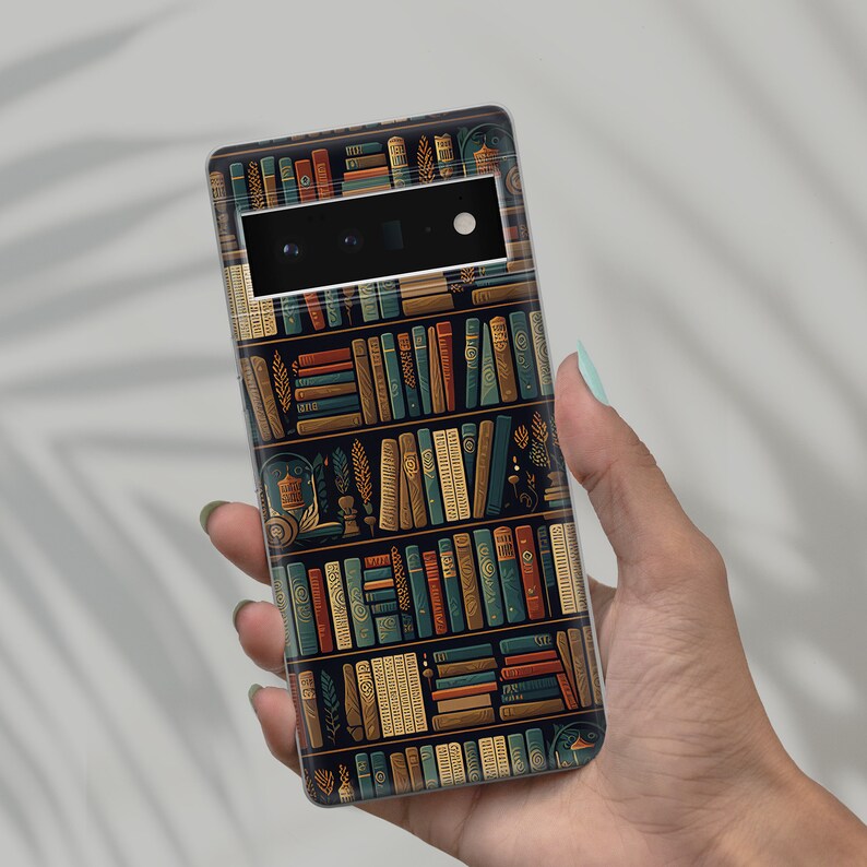 May include: A smartphone case featuring a detailed illustration of a bookshelf filled with various books. The design incorporates a dark background with rows of books in shades of blue, brown, and gold. The case is held in a person's hand.