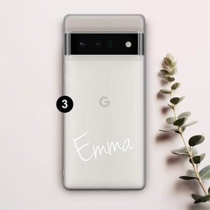 Op de afbeelding: Een witte telefoonhoes met een transparante achterkant en een zwarte camera lens. De hoes heeft een wit Google logo en de naam "Emma" in wit cursief.