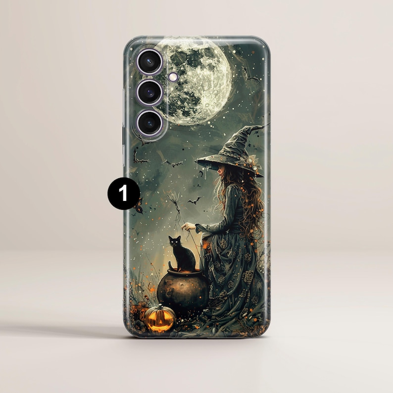 May include: A phone case with a witch and a black cat in front of a full moon. The witch is wearing a black dress and a pointed hat. The cat is sitting in a cauldron with a pumpkin next to it.