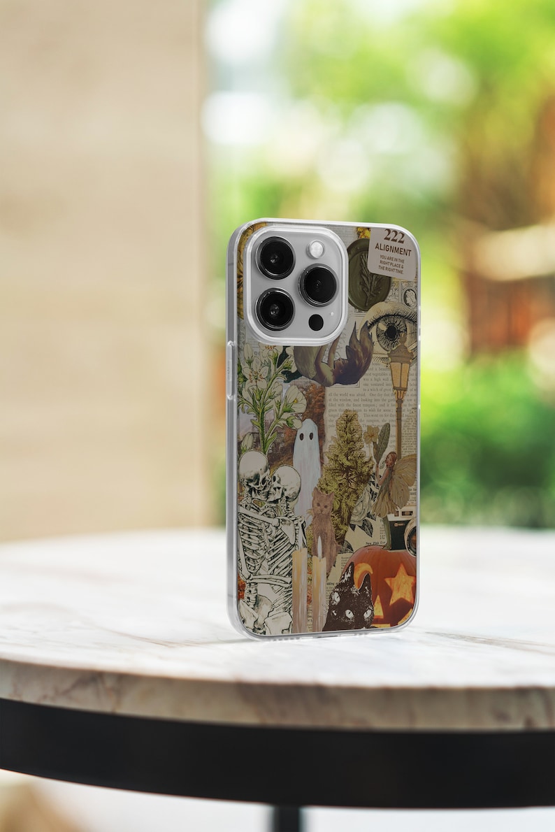 May include: A clear phone case with a collage of vintage Halloween imagery, including a skeleton couple, a ghost, a cat, a pumpkin, and a star. The text "222 ALIGNMENT YOU ARE IN THE RIGHT PLACE & THE RIGHT TIME" is visible on the case.