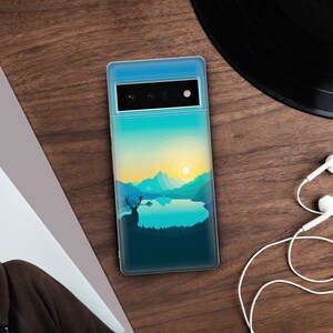 May include: A clear phone case with a scenic landscape design. The design features a lake, mountains, a sunset, and a silhouette of a deer.