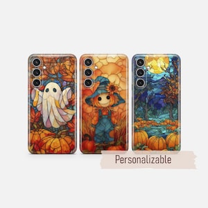 May include: Three smartphone cases featuring stained glass style autumn designs. The first shows a ghost among pumpkins, the second a scarecrow in overalls, and the third a moonlit pumpkin patch. The text "Personalizable" is printed below.
