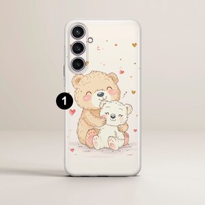 May include: A white phone case with a brown and white bear illustration. The bears are hugging and there are pink hearts scattered around them.