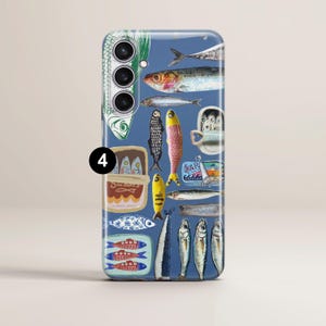 May include: A blue phone case with a sardine-themed design. The case showcases illustrations of sardines, sardine tins, and related imagery. The artwork includes various fish in different colors and styles, with text.