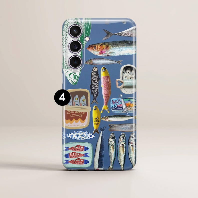 May include: A blue phone case with a sardine-themed design. The case showcases illustrations of sardines, sardine tins, and related imagery. The artwork includes various fish in different colors and styles, with text.