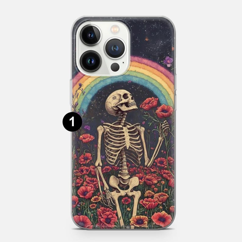 May include: A phone case with a skeleton figure standing in a field of red poppies. The skeleton is holding a poppy in its hand and a rainbow is in the background. The case is clear and has a black background.