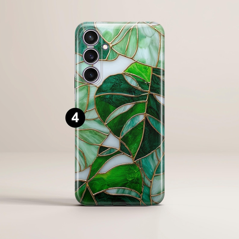 May include: A smartphone case with a stained-glass design featuring green leaf patterns and gold-colored outlines. The case has a glossy finish and a camera module with three lenses. The number "4" is printed on the case.