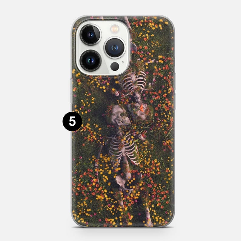 May include: A clear phone case with a design of two skeletons lying in a field of yellow and red flowers. The skeletons are intertwined and appear to be embracing.