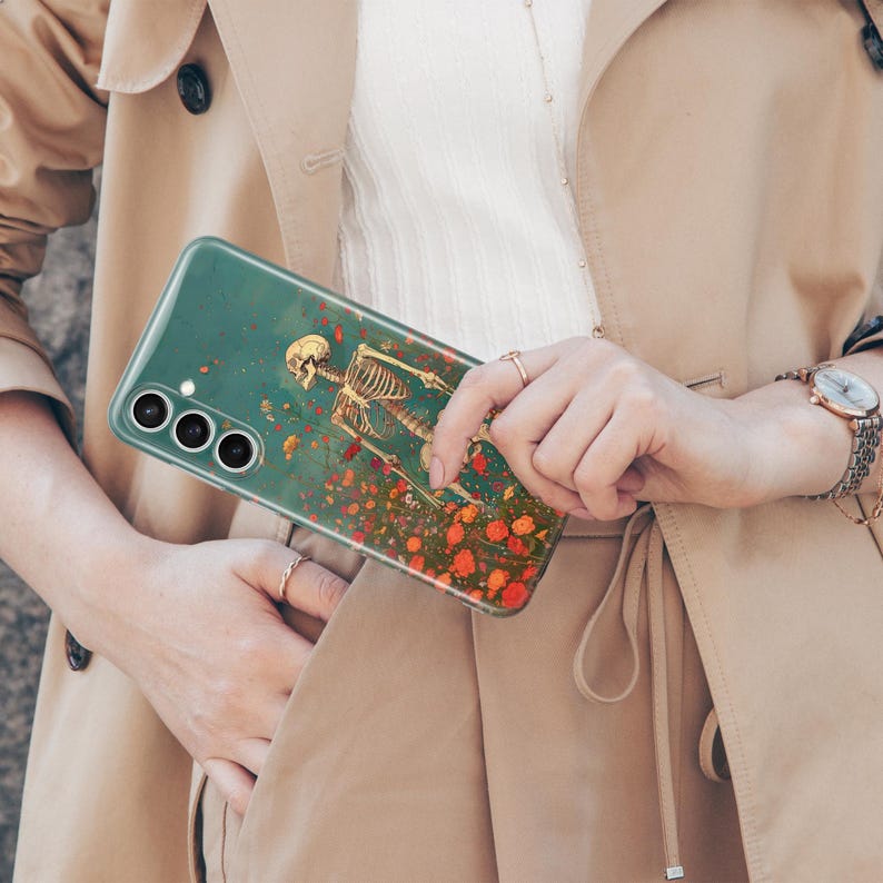 May include: A clear phone case featuring a skeleton standing in a field of red flowers. The case has a green tint and the skeleton is white.