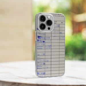 May include: A clear phone case with a library card design. The case has a date due section with handwritten dates from 1986 to 1989. The text "WILSON LIBRARY" is visible at the top of the case.