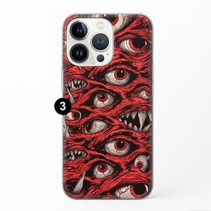 May include: A clear phone case with a red and black design featuring multiple eyes and mouths. The design is reminiscent of a grotesque, fleshy creature.