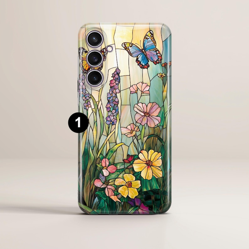 May include: A smartphone case featuring a stained-glass design with butterflies, flowers, and foliage in shades of yellow, pink, blue, and green. The case has a glossy finish and a camera module at the top.