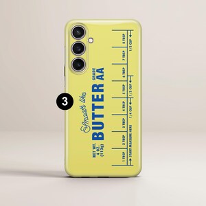 May include: A yellow phone case with a blue and white design that reads "Smooth like Butter AA Grade" and has a measurement guide for tablespoons and cups.