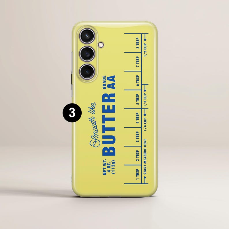 May include: A yellow phone case with a blue and white design that reads "Smooth like Butter AA Grade" and has a measurement guide for tablespoons and cups.