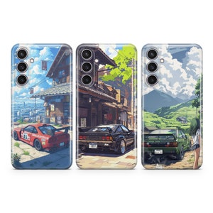 May include: Three phone cases with different designs. The first case features a red and white car driving down a street with a Japanese-style building in the background. The second case features a black car driving down a street with a Japanese-style building in the background. The third case features a green car driving down a road with a mountain in the background. All three cases have a white background.