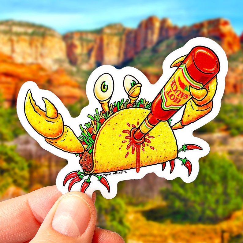 May include: A cartoon crab holding a taco with a bottle of hot sauce being poured into it. The hot sauce is labeled "Hot Sauce".