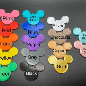 May include: A collection of colorful Mickey Mouse head-shaped items. Colors include pink, red, orange, yellow, green, light blue, blue, purple, gray, black, silver, chocolate, copper, ice blue, and rose gold. Each item has the color name printed on it.