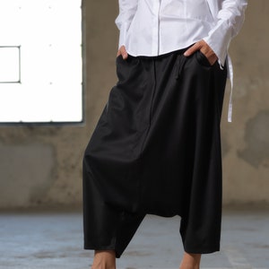 Black wool drop crotch pants with asymmetrical details, Avant-garde  pants Women, Baggy pants, Minimalist urban sustainable clothing