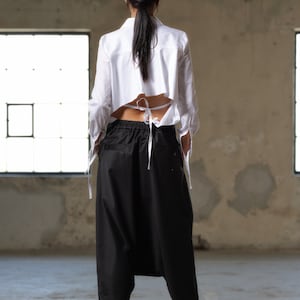 Black wool drop crotch pants with asymmetrical details, Avant-garde  pants Women, Baggy pants, Minimalist urban sustainable clothing