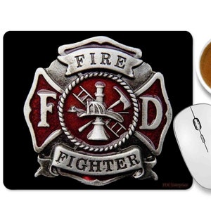 May include: Black rectangular mousepad featuring a red and silver firefighter emblem with the words "FIRE" and "FIGHTER". A white wireless mouse and a cup of coffee are also in the image.