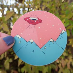 UFO Vinyl Sticker Featuring UFO and Mountains. Perfect for any Alien Lover.