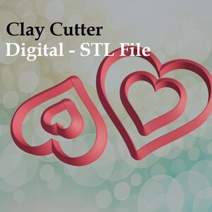 May include: Two red heart-shaped clay cutters, one with a single heart and the other with two nested hearts. The image includes the text "Clay Cutter Digital - STL File". The background is a gradient of green and white circles.