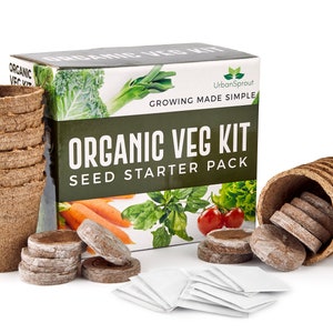 May include: An Organic Veg Kit seed starter pack. The image shows a box, seed starting pots, wooden plant markers, seed starting pellets, and small white seed packets. The box has images of vegetables and the text "Organic Veg Kit".