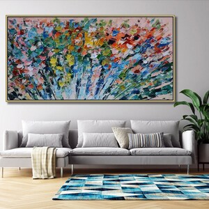 May include: Abstract painting with a colorful, textured, and brushstroke style. The painting features a variety of colors, including blue, green, yellow, orange, and red. The painting is framed in a gold frame and is hanging on a wall.