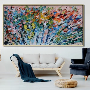 May include: Abstract painting with a colorful, textured, floral design. The painting is framed in a gold frame and is hanging on a white wall.