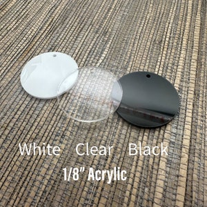 May include: Three acrylic circles: white, clear, and black. Each has a small hole for hanging. The text on the image reads "White Clear Black 1/8" Acrylic". These are suitable for crafting and DIY projects.