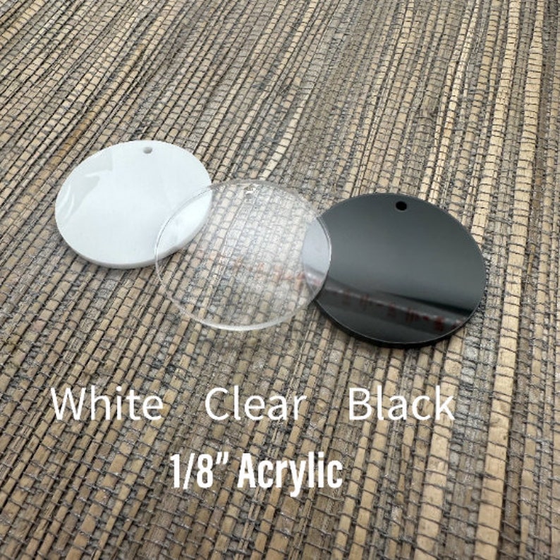 May include: Three acrylic circles: white, clear, and black. Each has a small hole for hanging. The text on the image reads "White Clear Black 1/8" Acrylic". These are suitable for crafting and DIY projects.